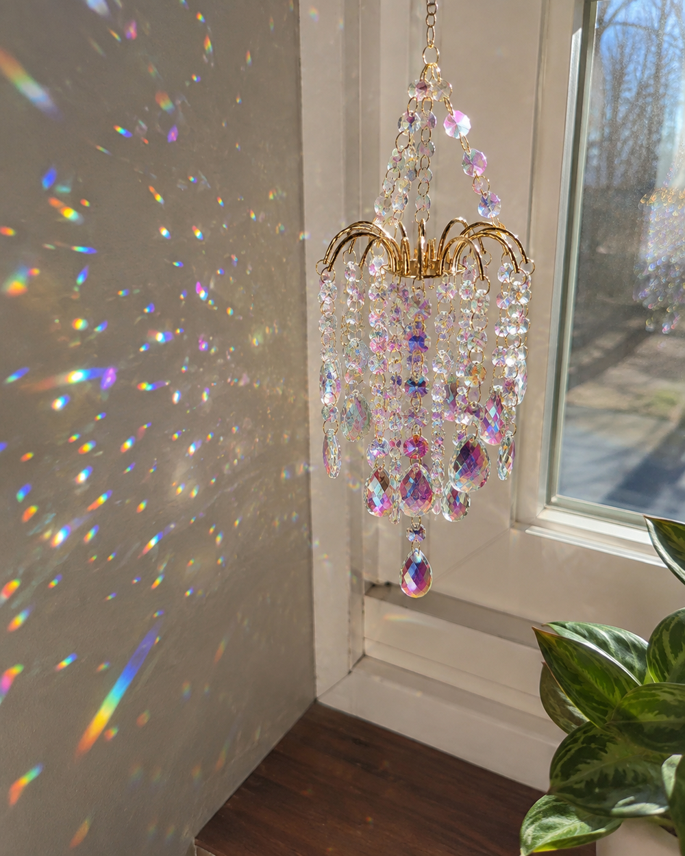 Rainbow reflections scattered across a wall beside a window