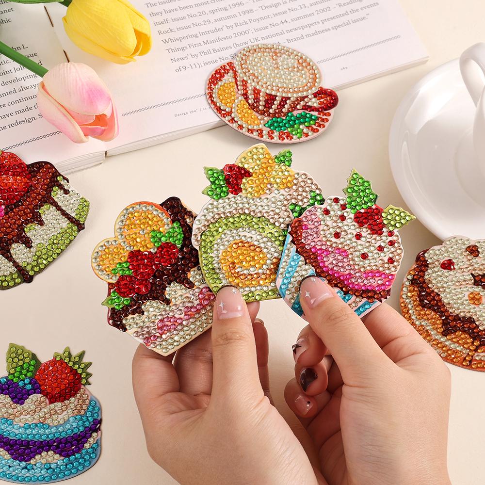 Hands holding finished DIY diamond art refrigerator magnets